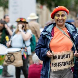 Black woman holding Drought Resistance sign