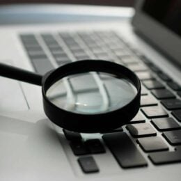 Magnifying glass on a laptop keyboard