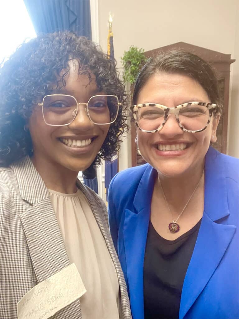Amina standing with Rep Tlaib, both smiling