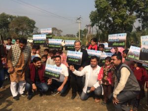 Group of villagers from Antwada, India holding signs