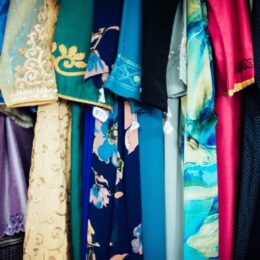Colorful clothes hanging up next to each other