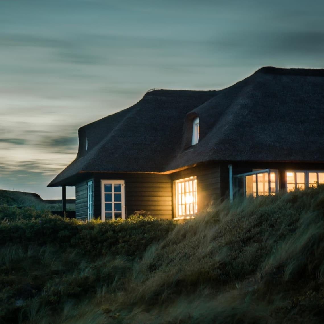 gray-house-with-fireplace-surrounded-by-grass-under-white-731082-1