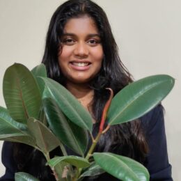 Manya Harsha holding a plant