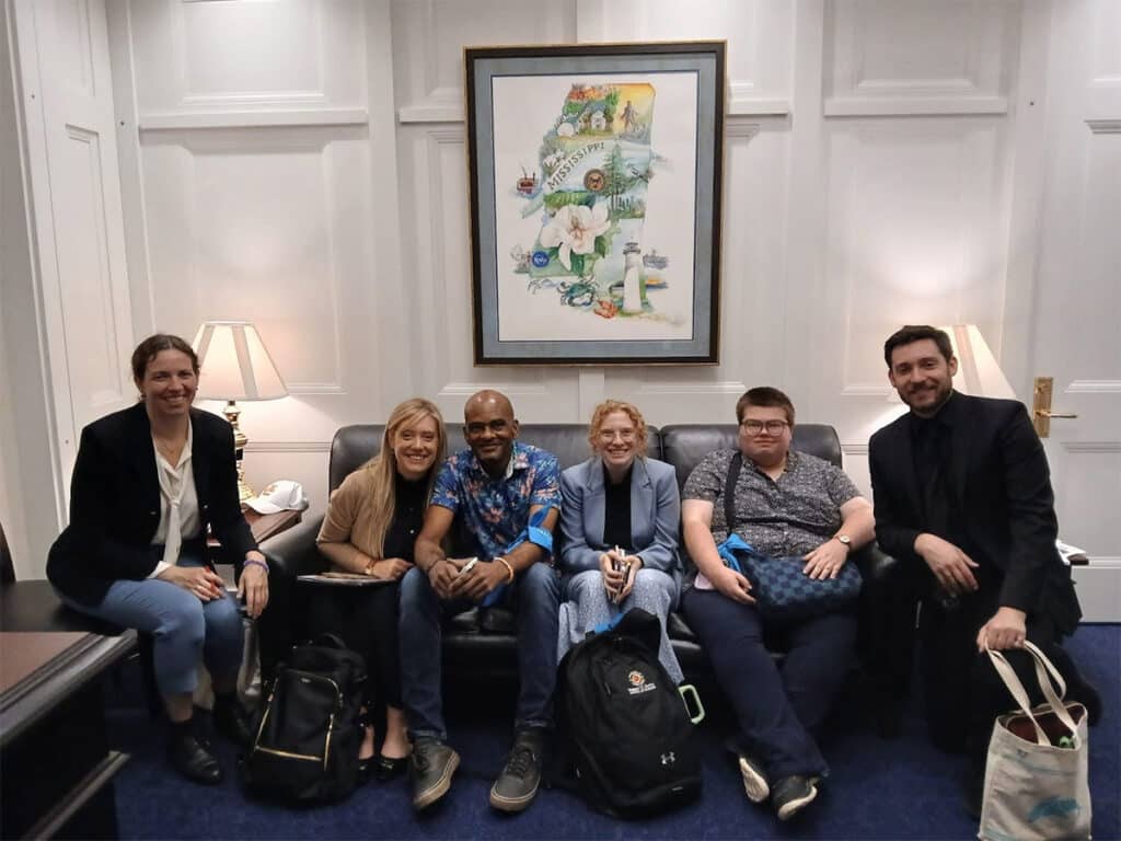 Members of Team Grouper, seated on a couch