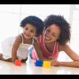 Photo of a mother and child playing with plastic toys