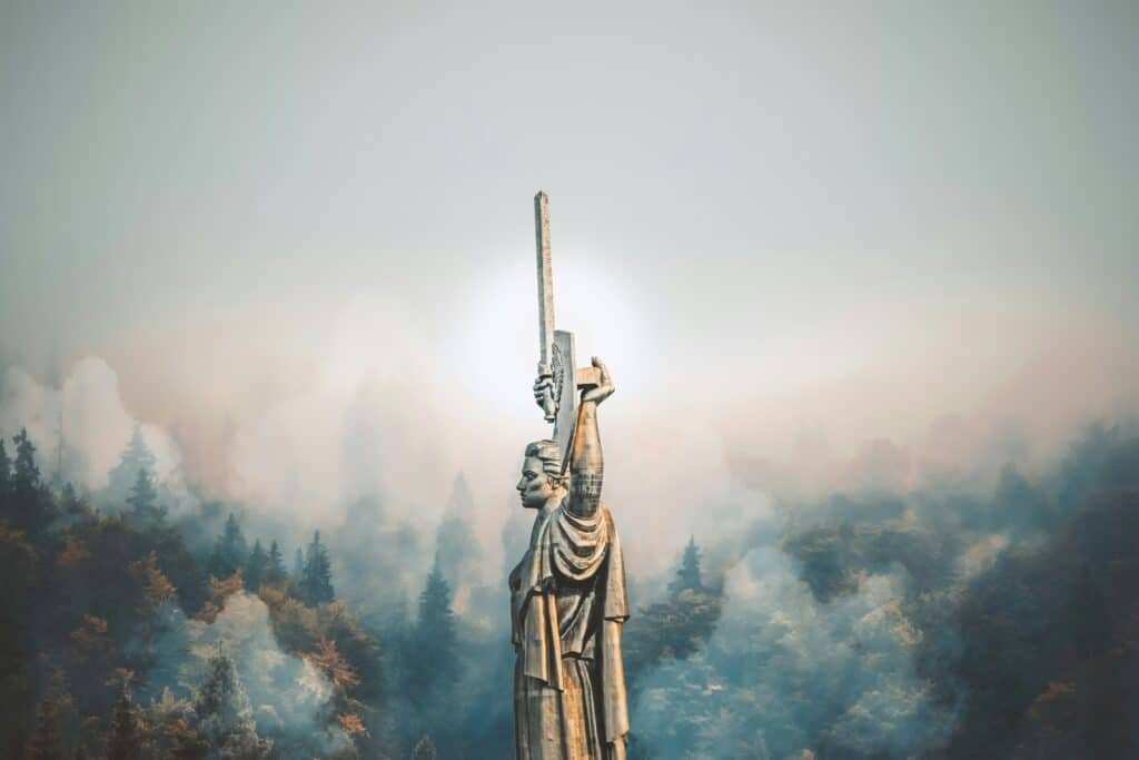 person standing on cliff painting -- Photo by Rostislav Artov on Unsplash