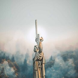 person standing on cliff painting -- Photo by Rostislav Artov on Unsplash