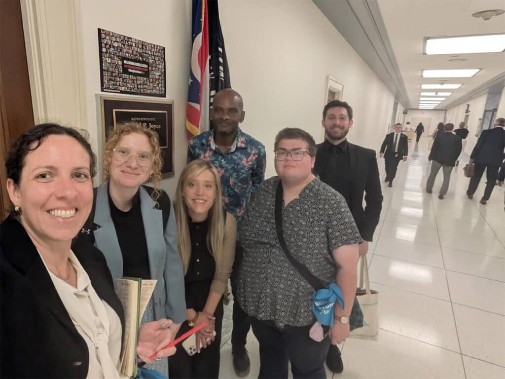 Five team members standing in the halls of the Rayburn House Office Building