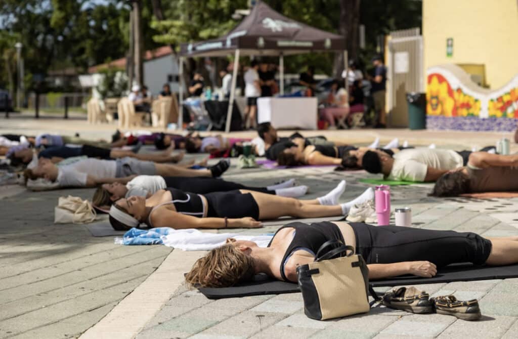 Volunteers doing yoga before the cleanup begins