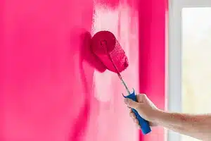 photo of paint roller making a wall pink