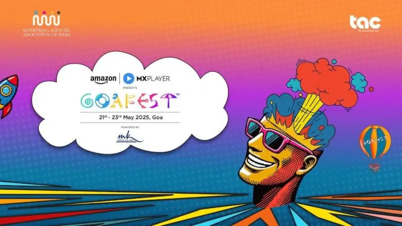 GoaFest poster image of a festival participant with sunglasses and wild hat/image of mind being blown, in a surreal landscape with hot air balloon